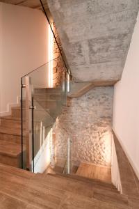 a staircase with a stone wall in a house at Cal Tonarro in Organyà