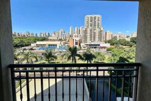 a balcony with a view of a city at Flat Mont Blanc Premium in Ribeirão Preto