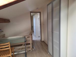 a room with a staircase and a door to a hallway at Petite maison proche cathédrale hyper centre in Toul