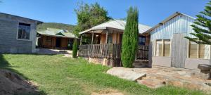 a house with a fence and a yard at KANUNKA HOUSE in Sekenani