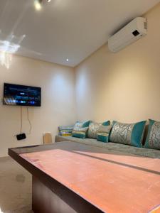 a ping pong table in a room with a couch at Modern Apartment Driouch 1 in Driouch