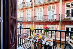 a table on a balcony with food and drinks at PAMPLONA CENTER SUITES luxury apartament City center in Pamplona