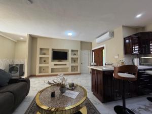 a living room with a couch and a table at 360 RokView Suites 3BR Spacious in Kingston