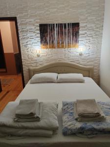 a bedroom with a bed with two towels on it at Weekendaya in Kladovo