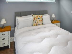 a large white bed with two night stands and two lamps at Oak Park Two - Uk50063 in Tiverton +11 photos