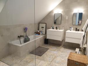 a bathroom with two sinks and a tub and a shower at Tomorrowland2026 Basecamp in Mechelen