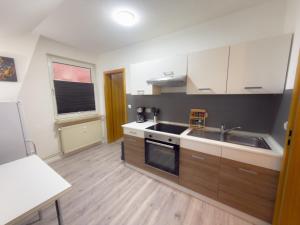 a kitchen with a sink and a stove top oven at HanseSuite zentral & charmante Ferienwohnung in Lübeck