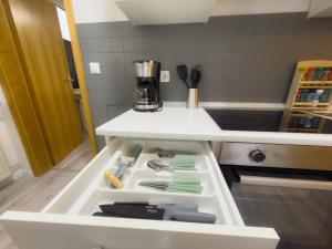 a drawer in a kitchen filled with utensils at HanseSuite zentral & charmante Ferienwohnung in Lübeck