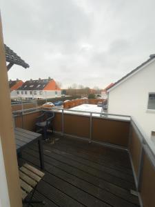 a balcony with a bench on top of a building at HanseSuite zentral & charmante Ferienwohnung in Lübeck