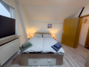 a bedroom with a bed with two pillows on it at HanseSuite zentral & charmante Ferienwohnung in Lübeck