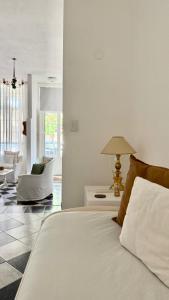 a bedroom with a bed with a lamp and a chair at V.60 in Nueve de Julio