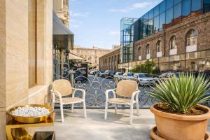 a patio with chairs and plants on a city street at Royal Renaissance Boutique by IGIT in Yerevan