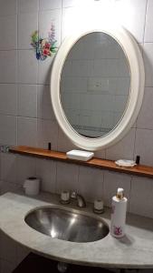 a bathroom sink with a large mirror above it at Casa Los colibrí in Frente Mar +35 photos