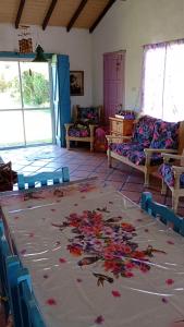 a room with a large rug with flowers on it at Casa Los colibrí in Frente Mar