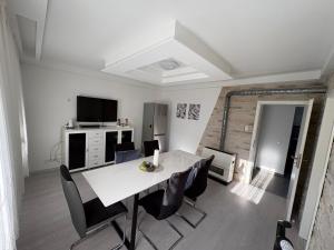 a dining room with a white table and chairs at HostelCetin in Göppingen