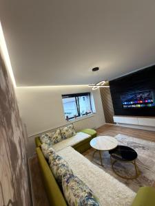 a living room with a couch and a table at Apartman Hendek Tuzla in Tuzla