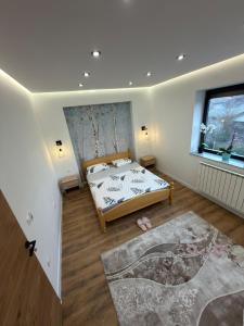 a bedroom with a bed and a large window at Apartman Hendek Tuzla in Tuzla