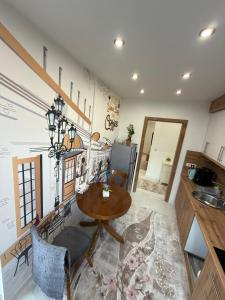 a kitchen with a table and a dining room at Apartman Hendek Tuzla in Tuzla