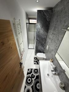 a bathroom with a sink and a toilet at Apartman Hendek Tuzla in Tuzla +10 photos