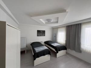 a bedroom with two beds and a window at HostelCetin in Göppingen