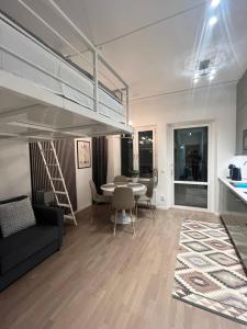 a living room with a couch and a table at Nordic NOVA Studio in Stockholm