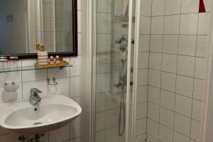 a bathroom with a sink and a shower at Gästehaus 3-Länderblick-Panoramablick in Mönichkirchen +53 photos