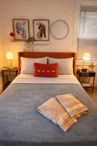 a bedroom with a bed with two towels on it at Urban Bedroom in Mount Vernon
