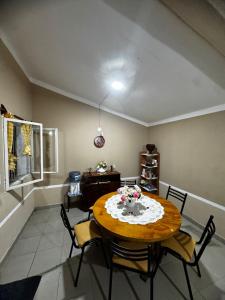 a dining room with a wooden table and chairs at Electra hospedaje familiar in Chicoana