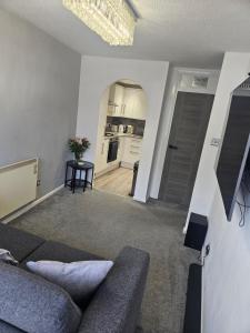 a living room with a couch and a kitchen at Flat 8 in Plymouth +9 photos