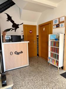 a room with a book shelf and a witch on the wall at Pensión O Regato in Redondela