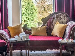 a couch in a window with pillows on it at Groudd Hall in Cerrigydrudion