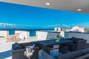 a living room with a large screen on the roof at Luxury Mandre Penthouse in Mandre