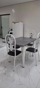 a table with two chairs and a table and a table and chairs at SSP Ubajara in Ubajara
