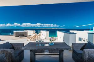 a patio with a table with wine glasses on it at Luxury Mandre Penthouse in Mandre