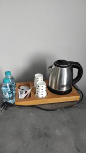 a tea kettle and cups on a wooden tray at Grand royal hotel in Gümüşyaka