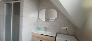 a bathroom with a sink and a mirror at Chambres Strasbourg in Strasbourg