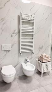 a white bathroom with a toilet and a sink at B&B Da Jana in Pordenone +23 photos