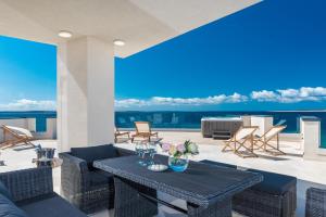 a patio with a table and chairs with a view at Luxury Mandre Penthouse in Mandre +69 photos