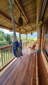 a porch with hammocks hanging from the ceiling at Cabaña Mirador Calima in Mediacanoa