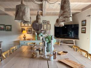 a dining room with a wooden table with chairs at Private Villa for 12 Peaceful Karst Escape in Dutovlje