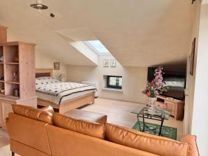 a living room with a couch and a bed at Private Villa for 12 Peaceful Karst Escape in Dutovlje