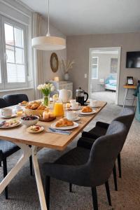 a dining room table with breakfast foods on it at Haus Gitta - Stilvolle Stadtoase in Luckenwalde