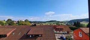 a view of roofs of buildings in a town at Pension Hauber - Hotzenwaldblick in Herrischried