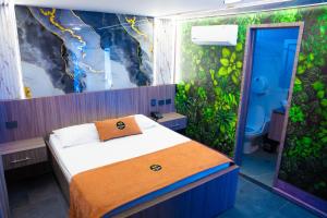 a bedroom with a bed and a mural at Hotel Bacatá Isla in Bucaramanga