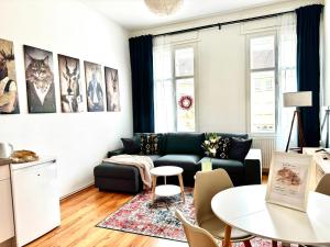 a living room with a couch and a table at Stadtquartier Luckenwalde in Luckenwalde +2 photos