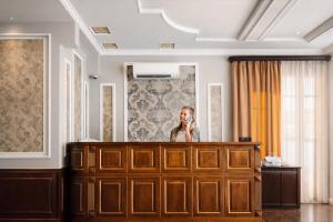 a woman is standing in front of a mirror at Royal Renaissance Boutique by IGIT in Yerevan