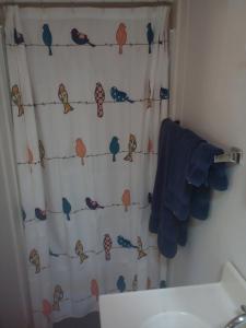 a bathroom with a shower curtain with birds on it at Redrockescapes in Sedona +24 photos