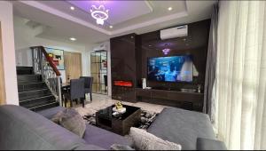 a living room with a couch and a flat screen tv at Luxury 3Bedroom Apartment in Sangotedo Ajah in Lekki
