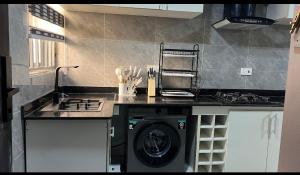 a kitchen with a stove and a washing machine at Luxury 3Bedroom Apartment in Sangotedo Ajah in Lekki
