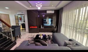 a living room with a couch and a table at Luxury 3Bedroom Apartment in Sangotedo Ajah in Lekki +1 photo